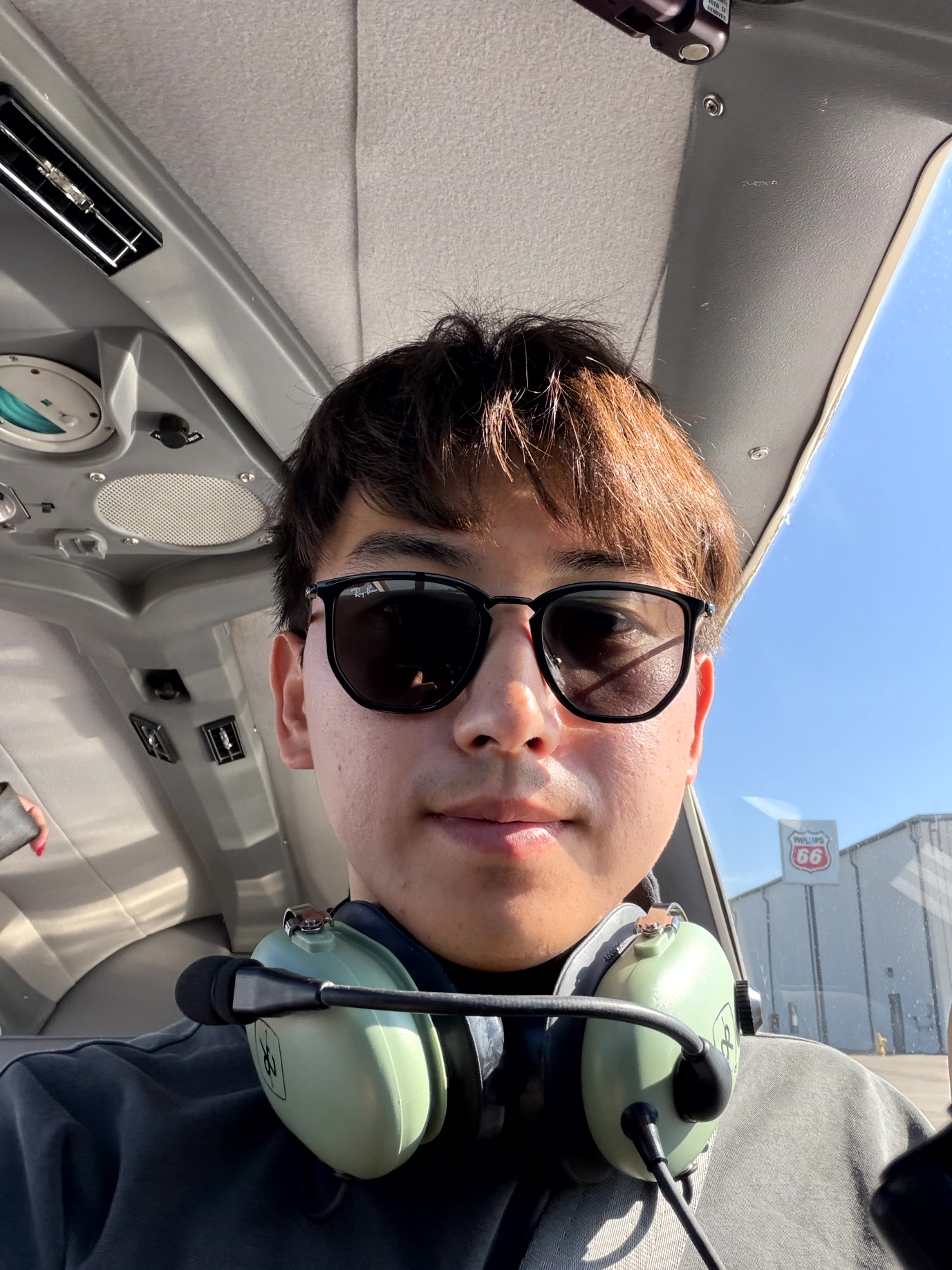 Yu-Kai wearing a headset in an aircraft cockpit