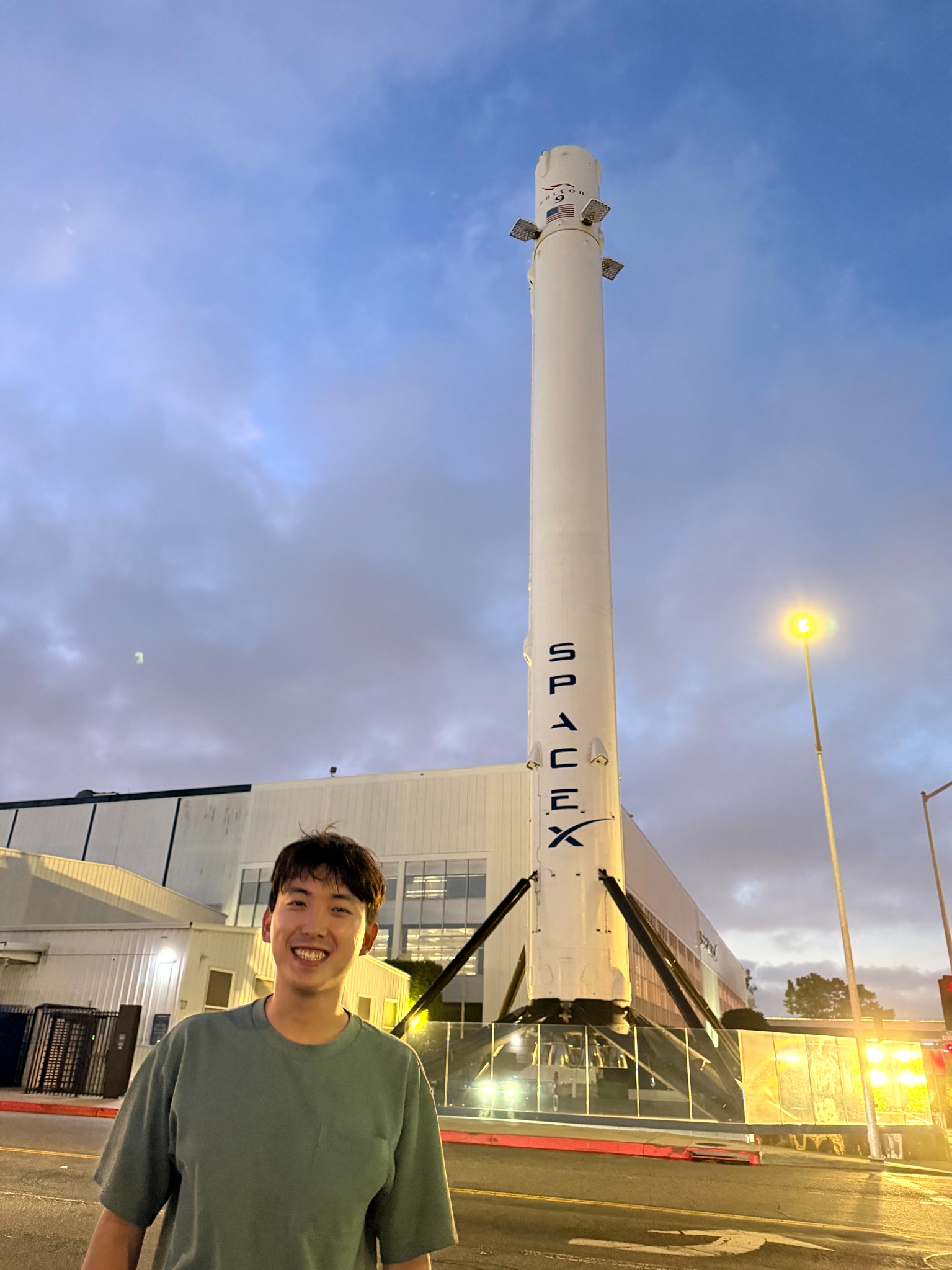 Yu-Kai standing in front of a displayed rocket booster